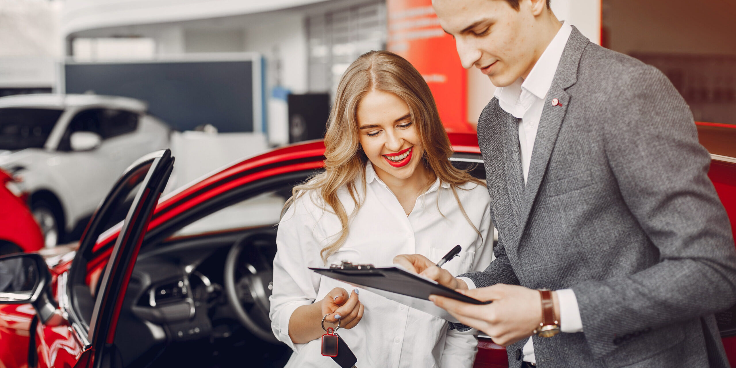 Two stylish woman in a car salon