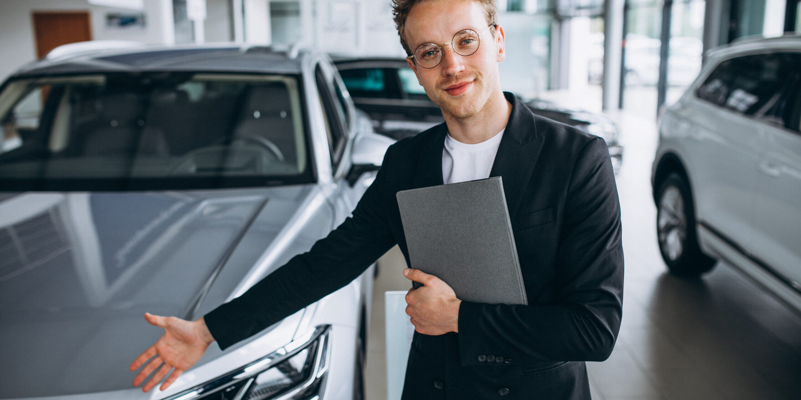Salesman at a car showroom